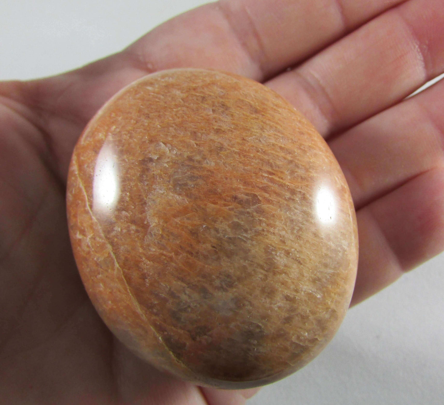peach moonstone crystal palmstone, worry stone, madagascar