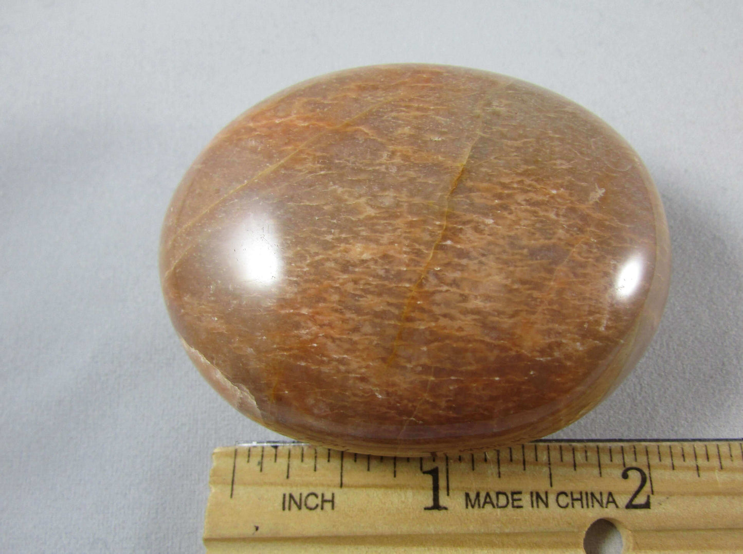 peach moonstone crystal palmstone, worry stone, madagascar