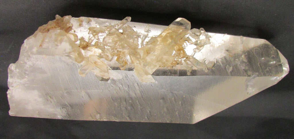 Clear crystal with embedded yellow crystals on a black background