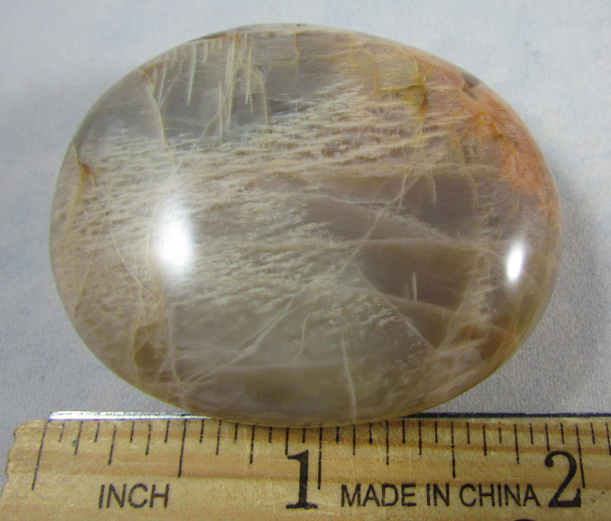 peach moonstone crystal palmstone, worry stone, madagascar