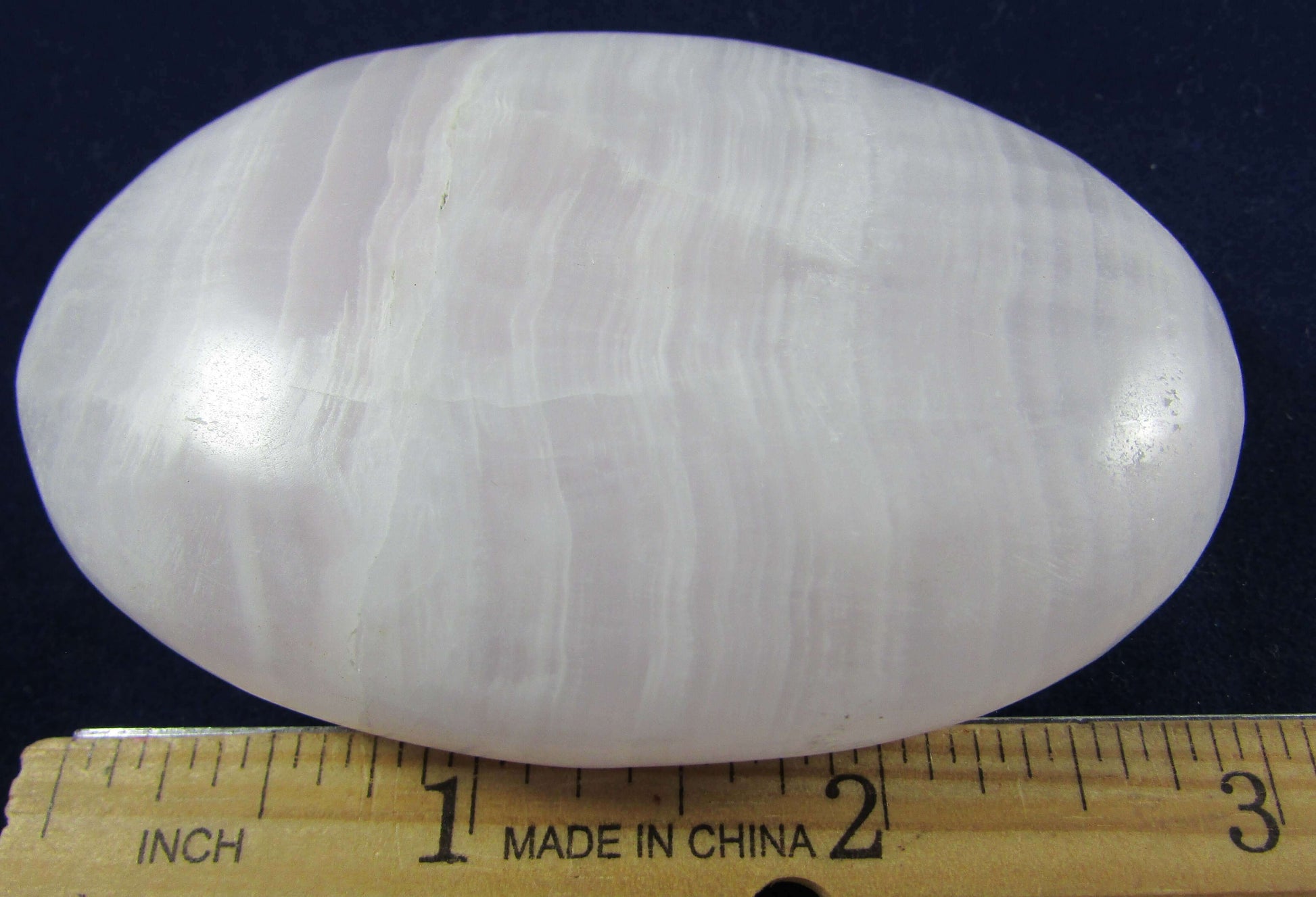 mangano calcite crystal sphere, polsihed palmstone