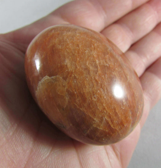 peach moonstone crystal palmstone, worry stone, madagascar