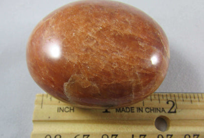 peach moonstone crystal palmstone, worry stone, madagascar