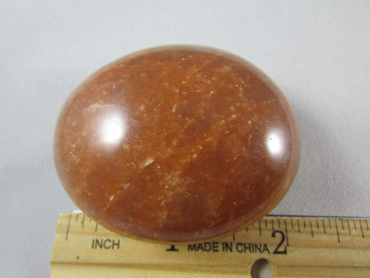 peach moonstone crystal palmstone, worry stone, madagascar