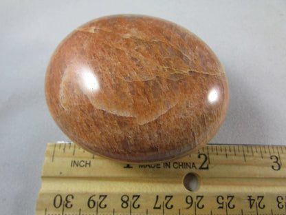 peach moonstone crystal palmstone, worry stone, madagascar